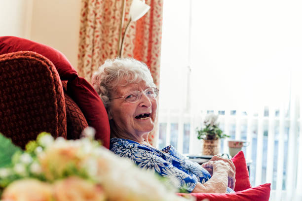 istock Senior Woman Sitting Laughing 938456892