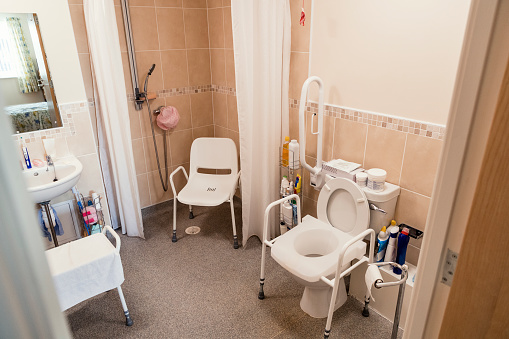 Bathroom with accessories to help with washing and using the toilet. Bathroom in a care home in England