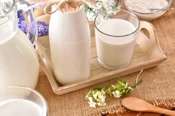 istock Container milk on tray with burlap on table outdoor 938464704