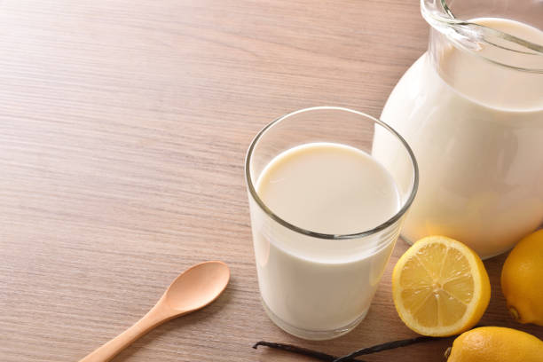 istock Glass of milk on wooden bench in rustic kitchen elevated 938464862