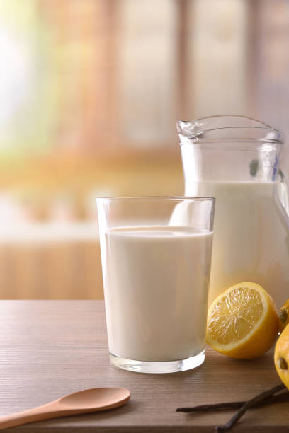 istock Glass of milk on wooden bench in rustic kitchen vertical 938464864