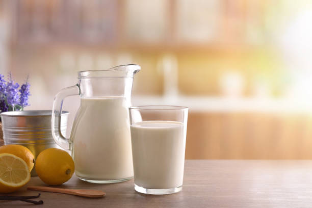 istock Glass of milk on wooden bench in a rustic kitchen 938464880