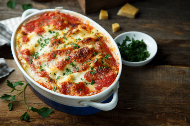 Homemade baked cannelloni Homemade baked cannelloni with tomatoes and cheese ricotta photos stock pictures, royalty-free photos & images