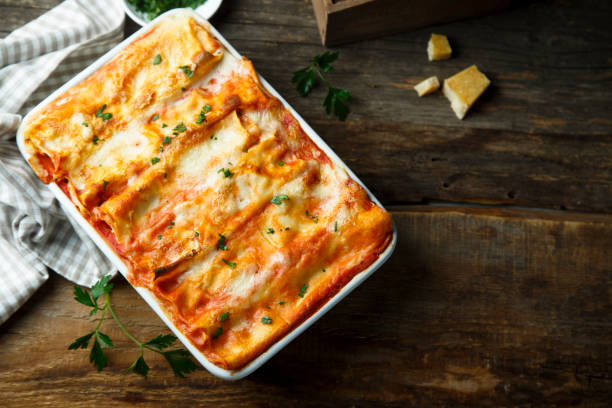 Homemade baked cannelloni Homemade baked cannelloni with tomatoes and cheese enchilada stock pictures, royalty-free photos & images