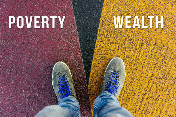 istock Concept of gap between poor and rich shown by shoes on different colored pathways 938472360