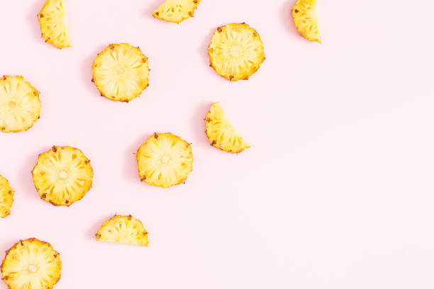 istock Pineapples on pink background. Flat lay, top view, copy space 938476506