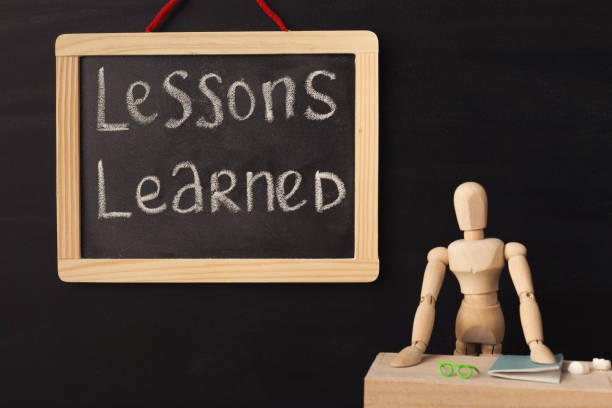 istock Wooden mannequin and chalkboard over black background 938476756