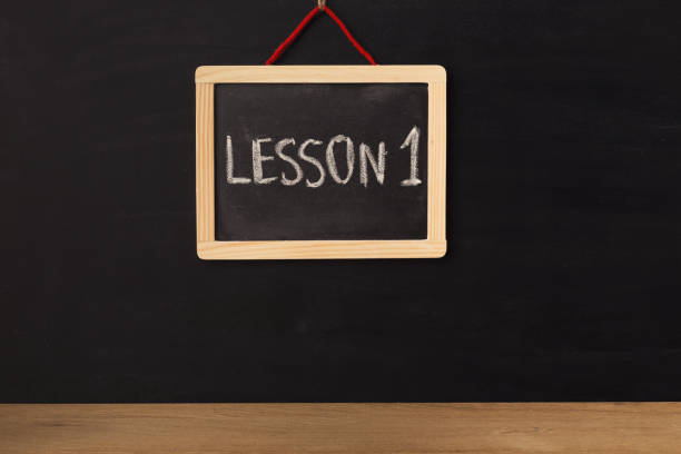 istock Word lesson 1 written on miniature chalkboard 938476798