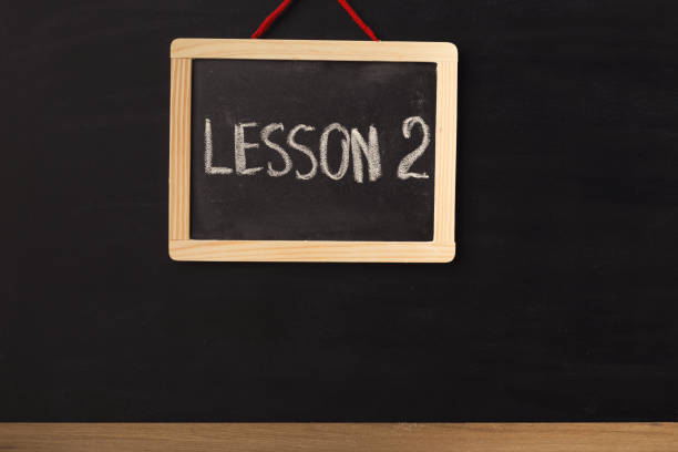 istock Word lesson 2 written on miniature chalkboard 938476846