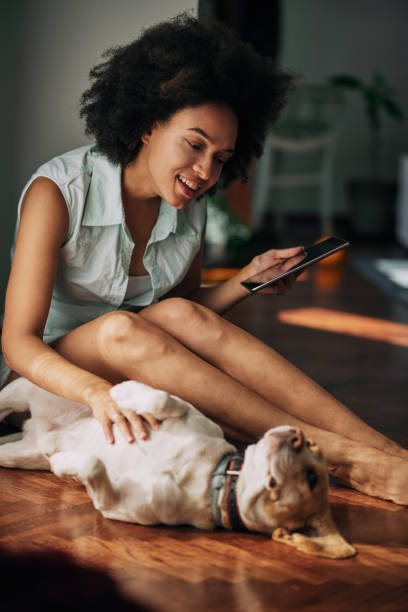 istock Mixed race woman petting dog. 938477208