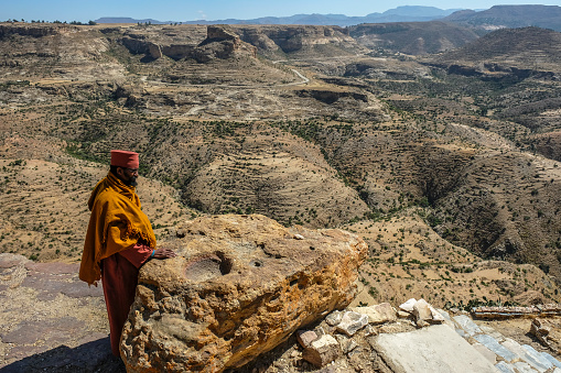 TIGRAY, ETHIOPIA - JANUARY 11: Priest looking over scarp at monastery Debre Damo on January 11, 2018 in Tigray Region, Ethiopia.