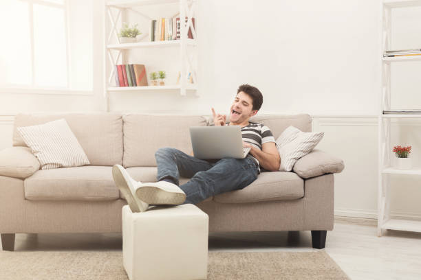 istock Happy man win. Winner, young man with laptop 938483976