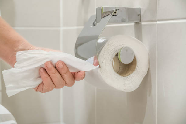 istock Woman using toilet paper. 938484184