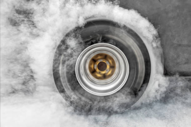 istock Drag racing car burn tire at start line 938484256