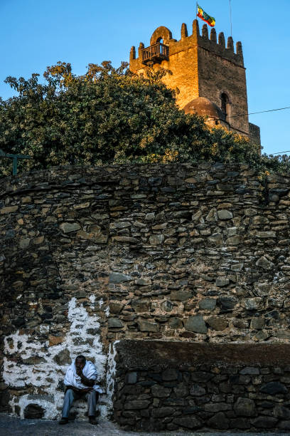 Male mountain biker rides down trail beside Sklabina castle ruins