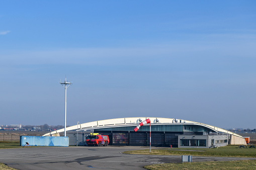 Airport Fire Department with an airfield fire engine in front of the building at Schiphol airport near Amsterdam in Holland.