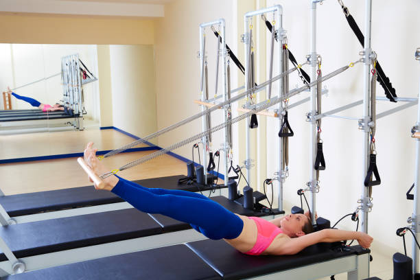 istock Pilates reformer woman long spine exercise 938487090