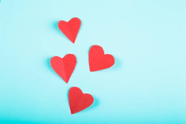 istock Paper hearts on blue background 938491878