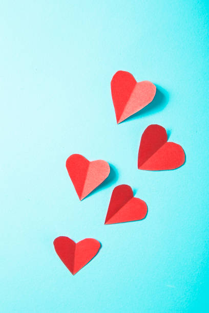 istock Paper hearts on blue background 938492456