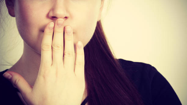 istock Woman covering her mouth with hand 938493644