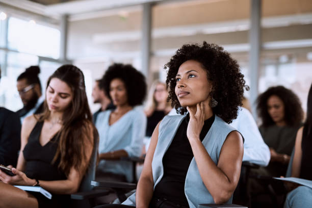 Content that she can relate to Shot of a businesswoman listening intently during a conference curiosity stock pictures, royalty-free photos & images