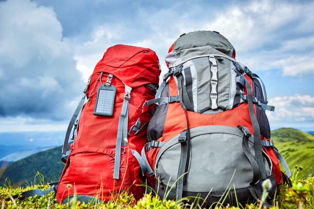 istock Backpacks in the mountains overlooking the mountains on the green grass. 938494510