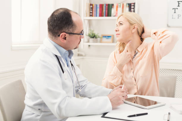 istock Blonde woman pointing at her neck 938494872