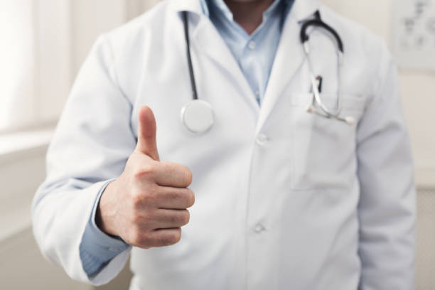 istock Unrecognizable doctor showing thumb up gesture 938495110