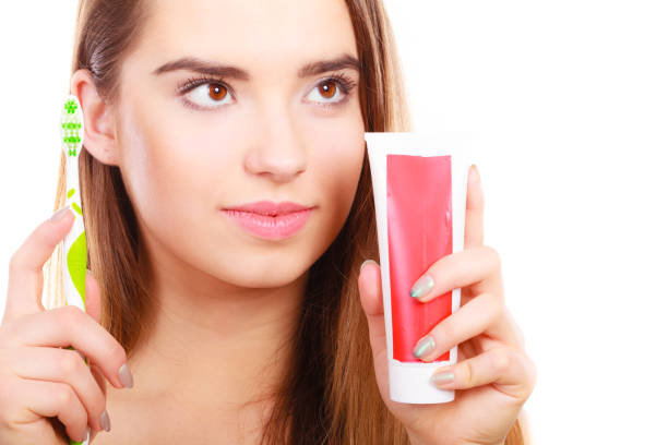 istock Woman holding toothbrush and toothpaste 938495170