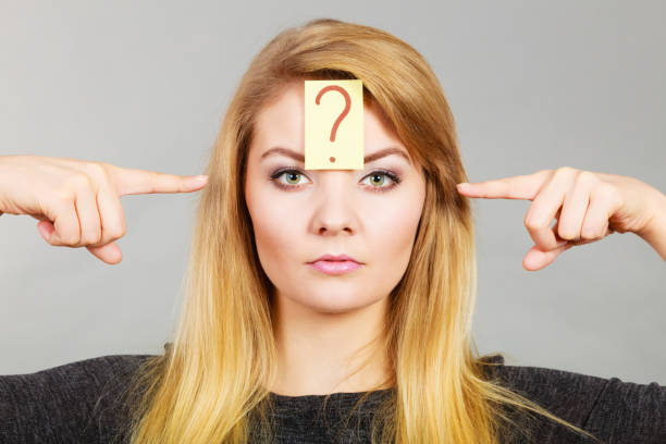istock Woman having question mark on forehead 938495296