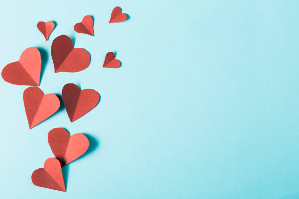 istock Paper hearts on blue background 938498320