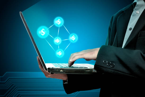 istock Businessman holding laptop with money network 938498350