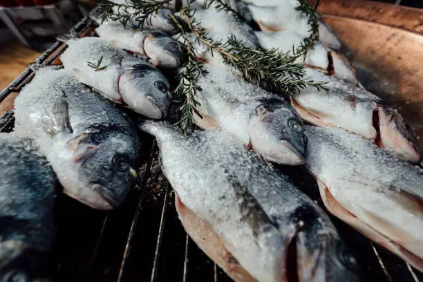 Photo of Fish preperation on a grill.