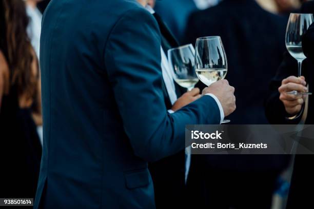 Couple Of Man With A Glass Of Wine At Social Event Wearing Elegant Cloth Stock Photo - Download Image Now