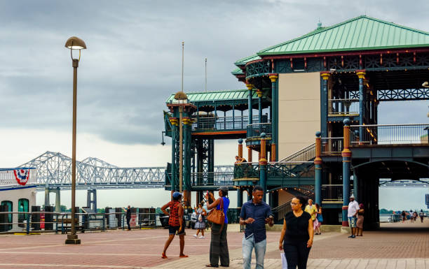 Historic multistorey pier structure at the Riverwalk New Orleans, USA - Aug 20, 2017: Historic multistorey pier structure at the Riverwalk, along the Mississippi River. Ornate retro architectural design platform with people walking in the area enjoying the tranquil atmosphere. named animal stock pictures, royalty-free photos & images