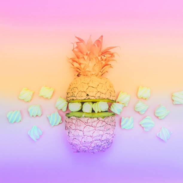 istock two painted halfs of the pineapple with marshmallow in gradient 938506486