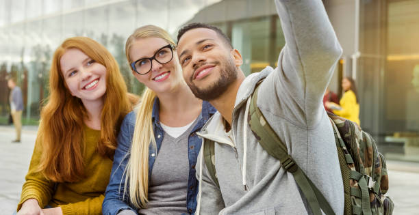 istock Students taking selfie with phone at university campus 938513588