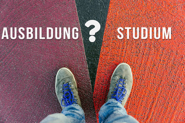 istock Concept of facing a crucial decision symbolized by ausbildung and studium in german meaning apprenticeship and study written on different colored pathways 938516074