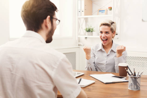 istock Young happy business partners in office with computer 938520122