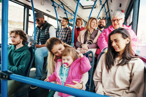 istock Cheerful baby is attraction for every passenger in the bus 938521062