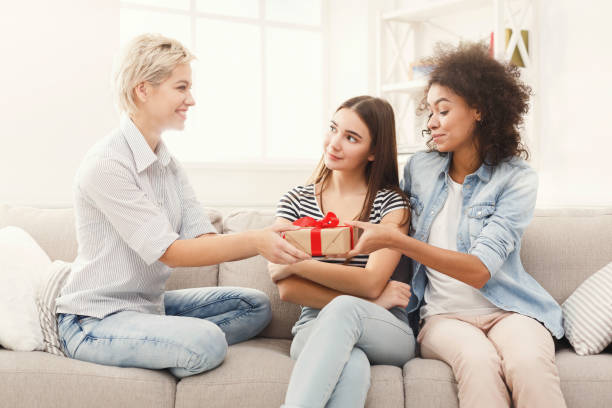 istock Excited woman getting gift from her friends 938523960