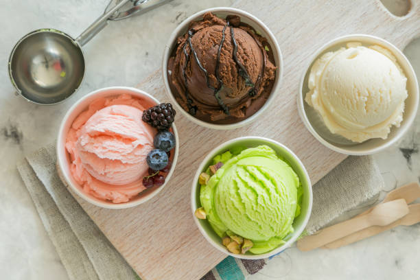 istock Selection of colorful ice cream scoops in paper cones 938524552