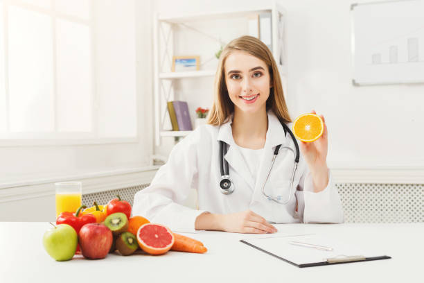 istock Dietitian nutritionist with fresh orange 938524650