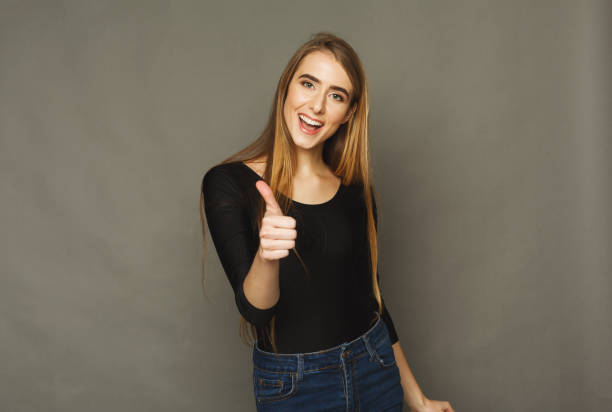 istock Pretty woman showing thumb up in studio 938524908