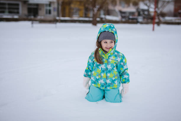 istock Cute girl playing in snow 938528786