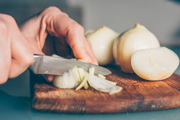 istock The cook cuts the onion on a cutting board 938535176