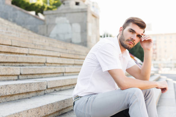 istock Thoughtful young man sitting outdoors 938535388