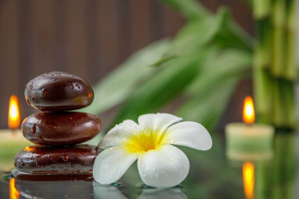 istock spa concept with candle, stone, flower and bamboo, relaxation 938536202