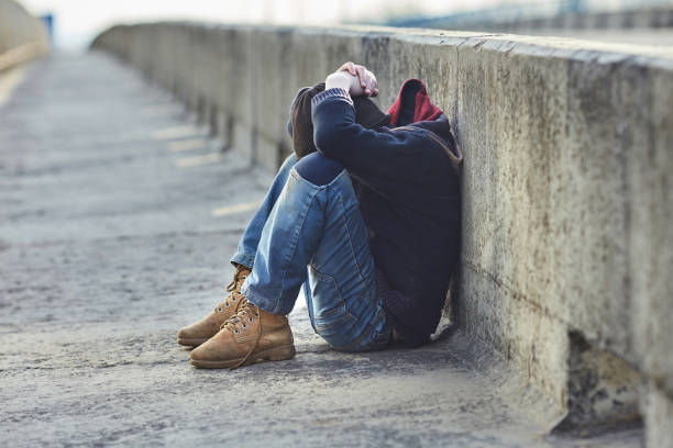 istock young homeless boy sleeping on the bridge 938536408