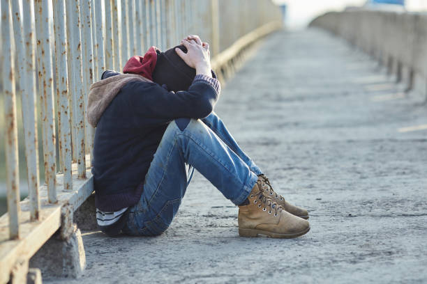 istock young homeless boy sleeping on the bridge 938536462